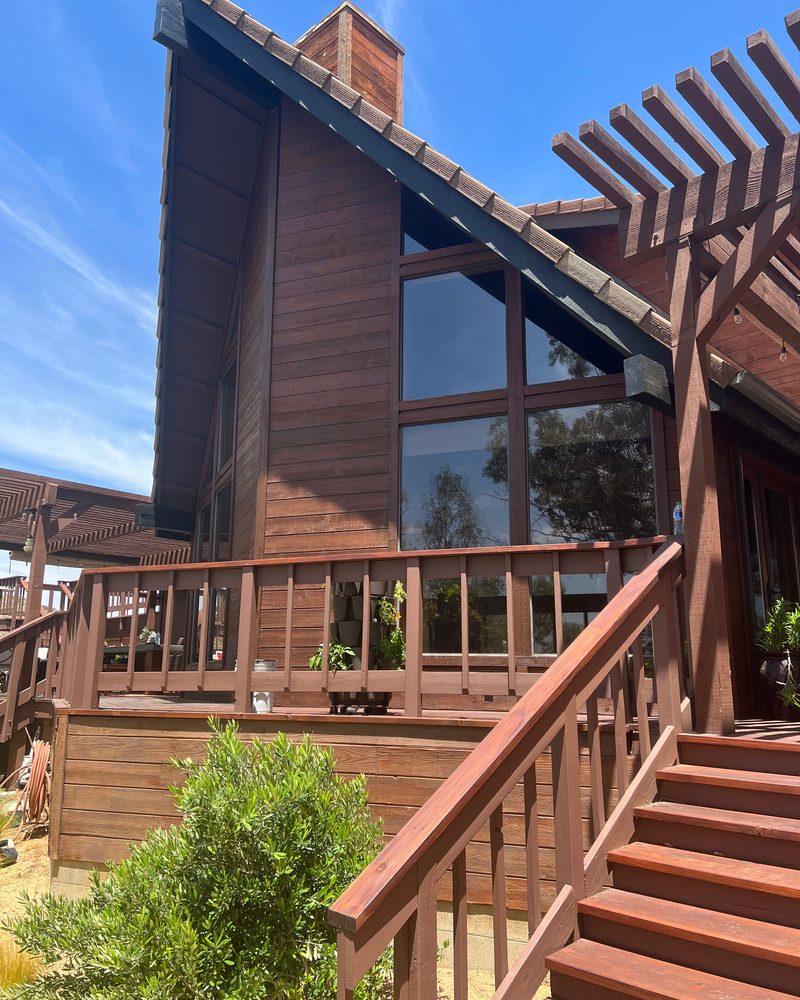 Wood-sided home exterior with freshly painted balcony